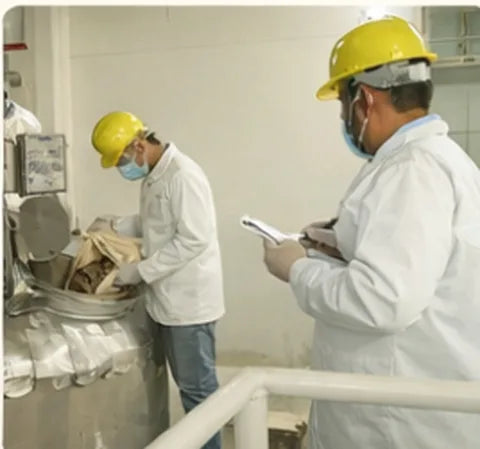 Batch records being checked by a quality inspector